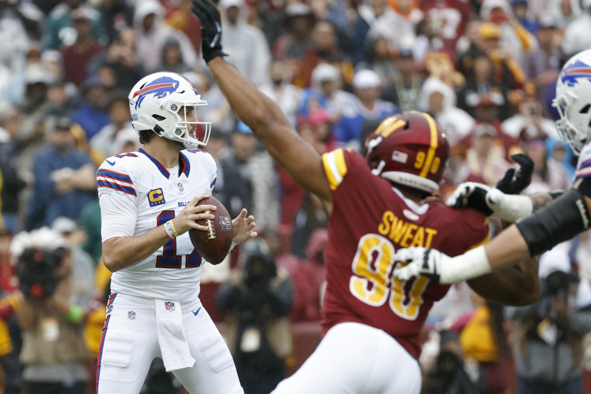 Josh Allen looks downfield as Washington's Montez Sweat attempts to find his team's first sack of the game.